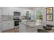 Modern kitchen featuring white cabinets, stainless steel appliances, and a granite countertop island with seating at 812 Canis Minor Rd, Wendell, NC 27591