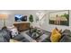 Comfortable living room featuring modern decor, a large sectional sofa, and stairs leading to the second floor at 812 Canis Minor Rd, Wendell, NC 27591
