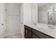 New bathroom with double vanity with white counters, dark cabinets and tiled shower at 84 Grove Township Way, Angier, NC 27501