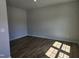 Bright bedroom featuring hardwood floors, ample natural light, and neutral walls at 84 Grove Township Way, Angier, NC 27501