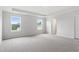 Spacious new bedroom with neutral carpet, tray ceiling, fresh paint and two large windows at 84 Grove Township Way, Angier, NC 27501