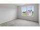 Neutral bedroom with plush carpet and bright windows showcasing the neighborhood at 84 Grove Township Way, Angier, NC 27501