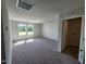 Spacious bonus room with soft carpet, large windows and attached full bath with washer/dryer hookups at 84 Grove Township Way, Angier, NC 27501