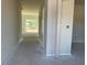 Light-filled entryway showcasing neutral walls and carpet leading to a bright living space at 84 Grove Township Way, Angier, NC 27501