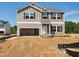 New two-story home with beige siding, black shutters, an open garage, and an unfinished front yard at 84 Grove Township Way, Angier, NC 27501