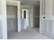 Unfinished hallway featuring gray walls and unfinished flooring at 84 Grove Township Way, Angier, NC 27501