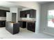 Spacious kitchen with dark wood cabinets and an unfinished island, ready for customization at 84 Grove Township Way, Angier, NC 27501