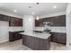 New kitchen featuring stainless appliances, dark cabinets, granite countertops and large island at 84 Grove Township Way, Angier, NC 27501