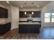 Modern kitchen with granite countertops, dark cabinets, stainless steel appliances and a center island at 84 Grove Township Way, Angier, NC 27501