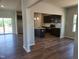 Open-concept kitchen with dark cabinetry, granite countertops, a center island, and modern stainless appliances at 84 Grove Township Way, Angier, NC 27501