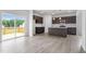 Spacious kitchen featuring stainless appliances, dark cabinets, granite countertops and a sliding door to the deck at 84 Grove Township Way, Angier, NC 27501