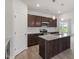New kitchen featuring stainless appliances, dark cabinets, granite countertops and an island with a sink at 84 Grove Township Way, Angier, NC 27501