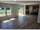 Spacious living area featuring wood-look floors and ample natural light with kitchen and outdoor access at 84 Grove Township Way, Angier, NC 27501