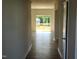 Bright, open-concept living room featuring wood-look flooring and sliding glass doors to the outdoor deck at 84 Grove Township Way, Angier, NC 27501