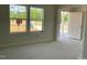 Living room bathed in natural light with large windows and white trim details at 84 Grove Township Way, Angier, NC 27501