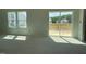 Bright living room featuring a sliding glass door to the deck and large windows at 84 Grove Township Way, Angier, NC 27501