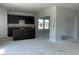 Open-concept living space with dark wood kitchen cabinets and a bright, airy ambiance at 84 Grove Township Way, Angier, NC 27501