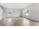 Open-concept area with modern flooring, white walls, and plenty of natural light from large windows at 84 Grove Township Way, Angier, NC 27501