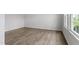 Bright room with modern flooring, white trim, lots of natural light, and freshly painted white walls at 84 Grove Township Way, Angier, NC 27501