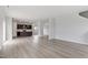 Spacious living area features modern flooring, and an open layout connecting the kitchen and living spaces at 84 Grove Township Way, Angier, NC 27501