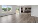 Bright living space with modern flooring, open layout connecting to the kitchen, and a sliding glass door at 84 Grove Township Way, Angier, NC 27501
