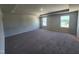 Large main bedroom featuring plush carpet, tray ceiling detail and plenty of natural light at 84 Grove Township Way, Angier, NC 27501