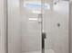Modern bathroom shower featuring tiled walls, a glass door, and sleek fixtures at 84 Grove Township Way, Angier, NC 27501