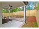 This covered patio features an outdoor sofa and wooded backyard at 1007 E Davie St, Raleigh, NC 27601