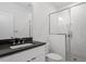 Modern bathroom featuring stone countertop and glass enclosed shower at 1007 E Davie St, Raleigh, NC 27601