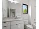Bright bathroom with white cabinets and large window at 1007 E Davie St, Raleigh, NC 27601