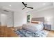 Spacious bedroom with a ceiling fan, hardwood floors, and natural light at 1007 E Davie St, Raleigh, NC 27601