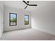 This bedroom features new carpet, a modern ceiling fan, and black-trimmed windows at 1007 E Davie St, Raleigh, NC 27601
