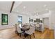 Dining area featuring hardwood floors and modern lighting adjacent to the kitchen and living area at 1007 E Davie St, Raleigh, NC 27601