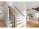 Entryway staircase with wooden handrail and black iron balusters leading to the upper level at 1007 E Davie St, Raleigh, NC 27601
