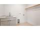 Unfinished laundry room with utility sink, storage, and connections at 1007 E Davie St, Raleigh, NC 27601
