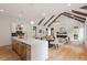 Open concept living area with hardwood floors, vaulted ceiling, and exposed wooden beams at 1007 E Davie St, Raleigh, NC 27601