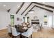 Open concept living area with hardwood floors, vaulted ceiling, and exposed wooden beams at 1007 E Davie St, Raleigh, NC 27601