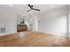 Large living room with hardwood floors and a ceiling fan at 1007 E Davie St, Raleigh, NC 27601