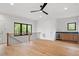 Open living space with hardwood floors, balcony, and wet bar at 1007 E Davie St, Raleigh, NC 27601