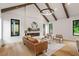 Bright living room with hardwood floors, a modern fireplace, and exposed ceiling beams at 1007 E Davie St, Raleigh, NC 27601