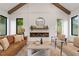 Cozy living room featuring vaulted ceiling with wooden beams and modern fireplace at 1007 E Davie St, Raleigh, NC 27601