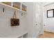 Well-lit mudroom with bench, hooks, and built-in shelving at 1007 E Davie St, Raleigh, NC 27601