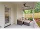 This covered patio features a ceiling fan, seating, and fenced-in yard at 1007 E Davie St, Raleigh, NC 27601