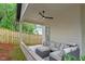 Covered outdoor patio with comfortable seating and a ceiling fan, overlooking a fenced yard at 1007 E Davie St, Raleigh, NC 27601