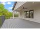 This spacious porch has a ceiling fan, and iron railing overlooking the yard at 1007 E Davie St, Raleigh, NC 27601
