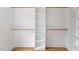 Walk-in closet with built-in shelving and hardwood floors providing ample storage space at 1007 E Davie St, Raleigh, NC 27601