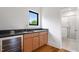 Convenient wet bar and sink area adjacent to a full bathroom at 1007 E Davie St, Raleigh, NC 27601