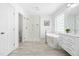 Bright white bathroom with glass enclosed shower, a soaking tub, and modern finishes at 101 Vista Brooke Dr, Morrisville, NC 27560