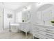 Bright white bathroom features dual vanities, a soaking tub, and modern finishes at 101 Vista Brooke Dr, Morrisville, NC 27560
