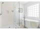 Bright white bathroom with glass enclosed shower and soaking tub at 101 Vista Brooke Dr, Morrisville, NC 27560